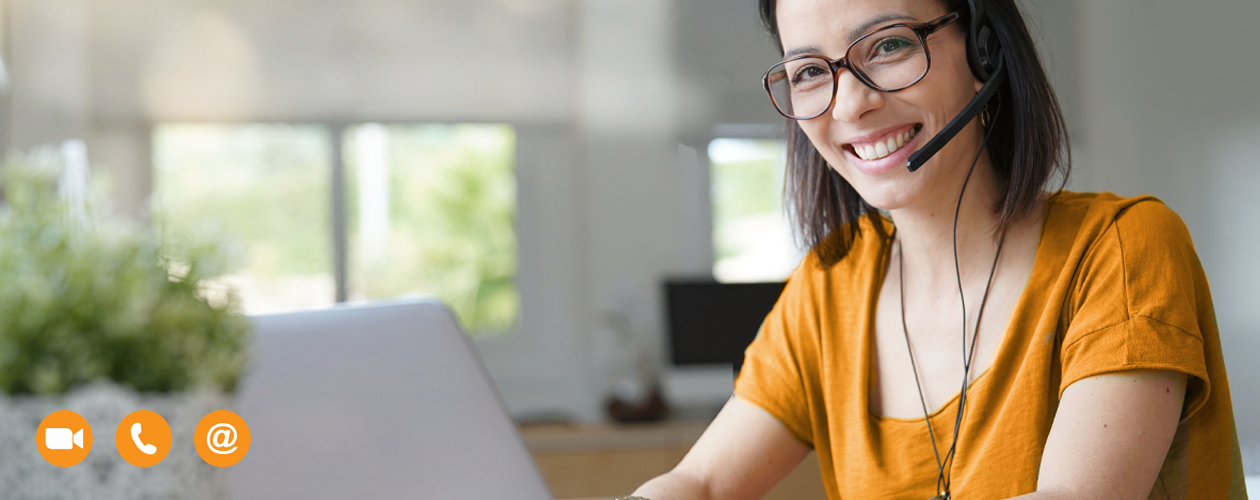young woman with headset working on laptop