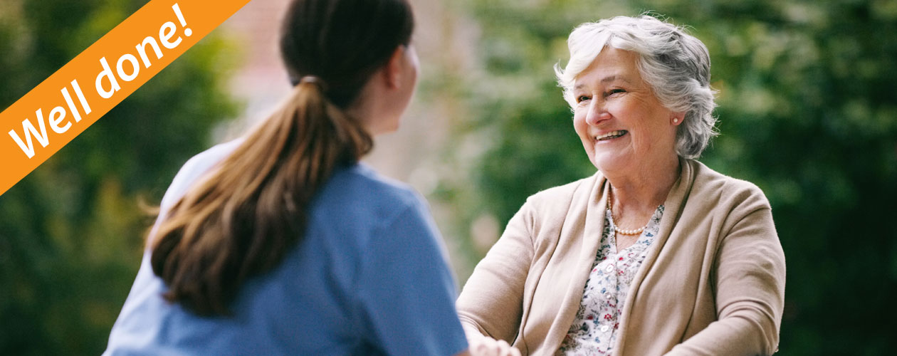 aged care worker chatting with older woman