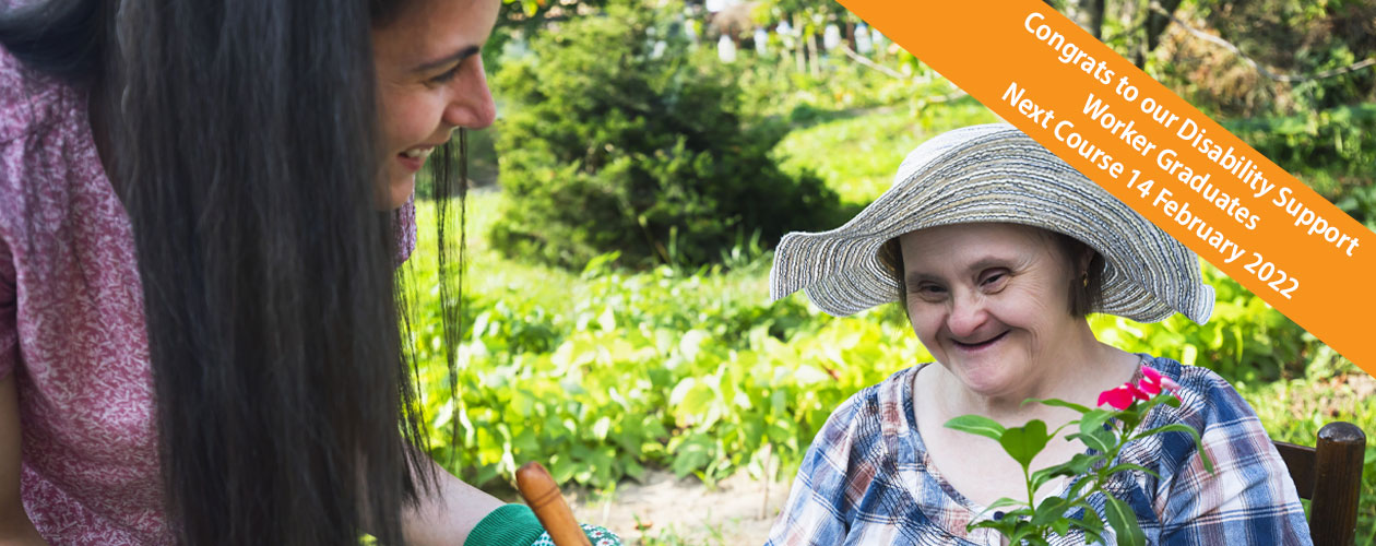 woman with down syndrome and her support worker planting a tree