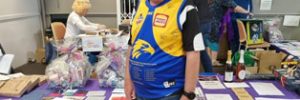 Rick in front of fundraising table