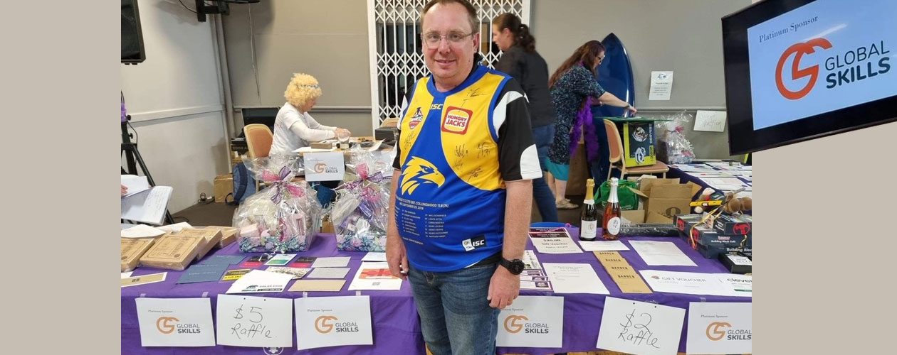 Rick in front of fundraising table