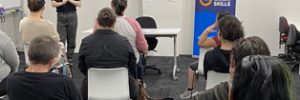 job seekers on chairs focussing on presenter at front of room