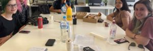 group of young people sitting around table