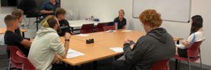 TtW young people sitting at table with Global Skills staff