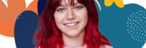 Young woman with red hair standing in front of vector flower graphic