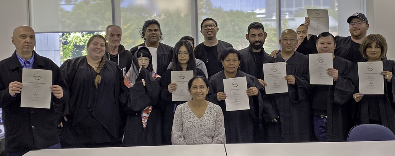 graduates holding certificates