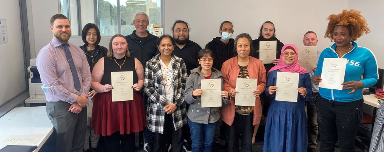 graduates holding certificates