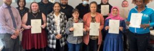 graduates holding certificates