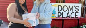 staff member handing good boxes to doms house staff member