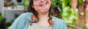 young down syndrome woman working in nursery