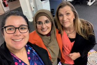 3 of our staff in orange