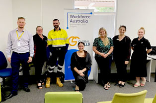 employers and Global Skills Staff standing around our banner