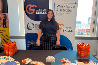 our stall with a staff member standing behind the table
