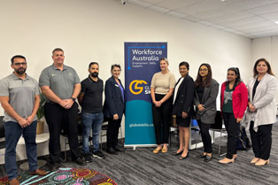 employers and Global Skills staff standing around our banner