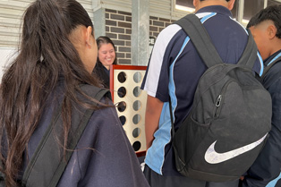 Students playing connect 4 at our stall