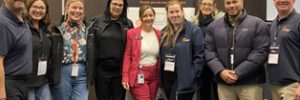 group pic of Global Skills attendees standing in front of the Puzzle Conference banner