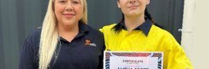 Amelia proudly holding her certificate alongside Employment Consultant Hayley