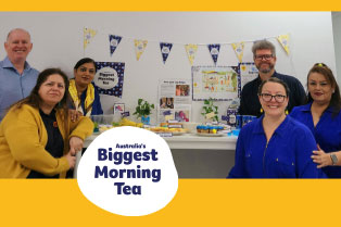 Our Brookvale team in blue and yellow with their Biggest Morning Tea themed morning tea