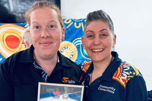 aura holds the certificate presented to Global Skills, standing beside Antoinette from Bankstown Community Corrections.