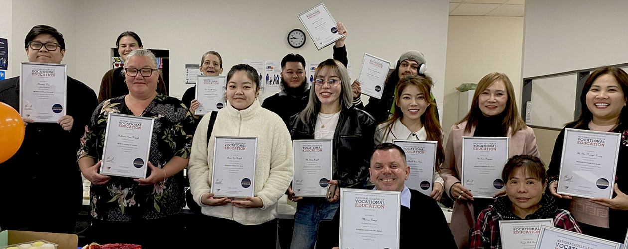 Graduates with their certificates