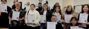 Graduates with their certificates