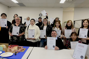 Graduates with their certificates