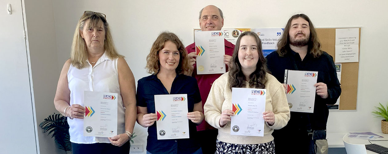 Graduates holding their certificates