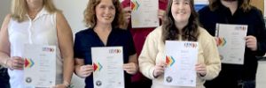 Graduates holding their certificates