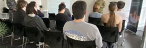 Participants seated, attentively listening to the presentation by Australian Defence Force personnel