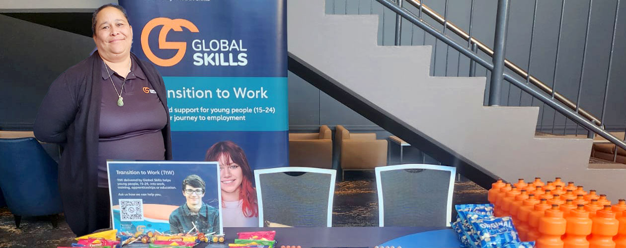 Jennifer is behind the table at our stall, with Global Skills' Workforce Australia banner beside her