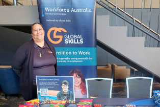 Jennifer is behind the table at our stall, with Global Skills' Workforce Australia banner beside her