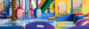 A cafe table and chairs with play equipment in the background