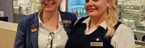 Tianna and Dianne smiling together in front of a bar at the club