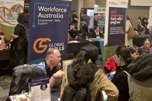 Trent conversing with attendees at our stall during the expo