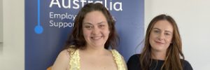 Alanah and Zoe standing in front of a Global Skills banner.