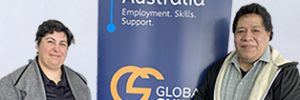Enimoa and Vanessa standing on either side of a Global Skills banner that reads "Workforce Australia: Employment. Skills. Support." The banner includes the Global Skills logo and website.