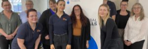 Staff standing in front of Global Skills WFA banner