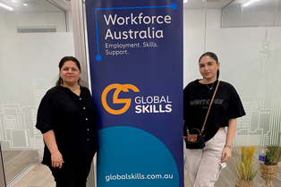 Azita and Mariam standing on either side of a Global Skills banner that reads "Workforce Australia: Employment. Skills. Support." The banner includes the Global Skills logo and website.