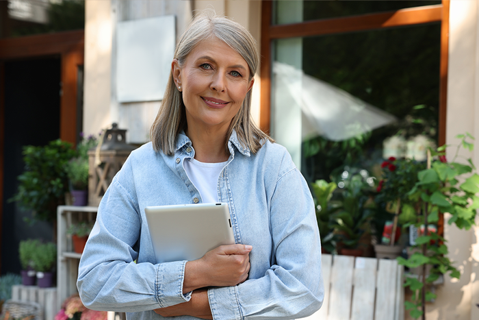 a mature lady holding an iPad