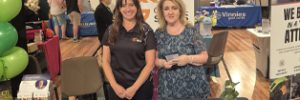 Global Skills team, Nancy and Kim, standing in front of Global Skills’ Inclusive Employment Australia banner at the Expo