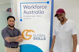 Youssef and Colin standing either side of Global Skills’ Workforce Australia banner at Global Skills Fairfield.