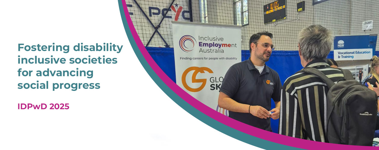 Image includes this year’s theme, “Fostering disability inclusive societies for advancing social progress,” in teal text, along with the IDPwD logo, the Inclusive Employment Australia (IEA) logo, and the Global Skills logo. On the right, a photo shows Robert at our event stall speaking with a participant. Behind them is the Global Skills IEA banner. A curved teal and magenta design separates the text and the photo.