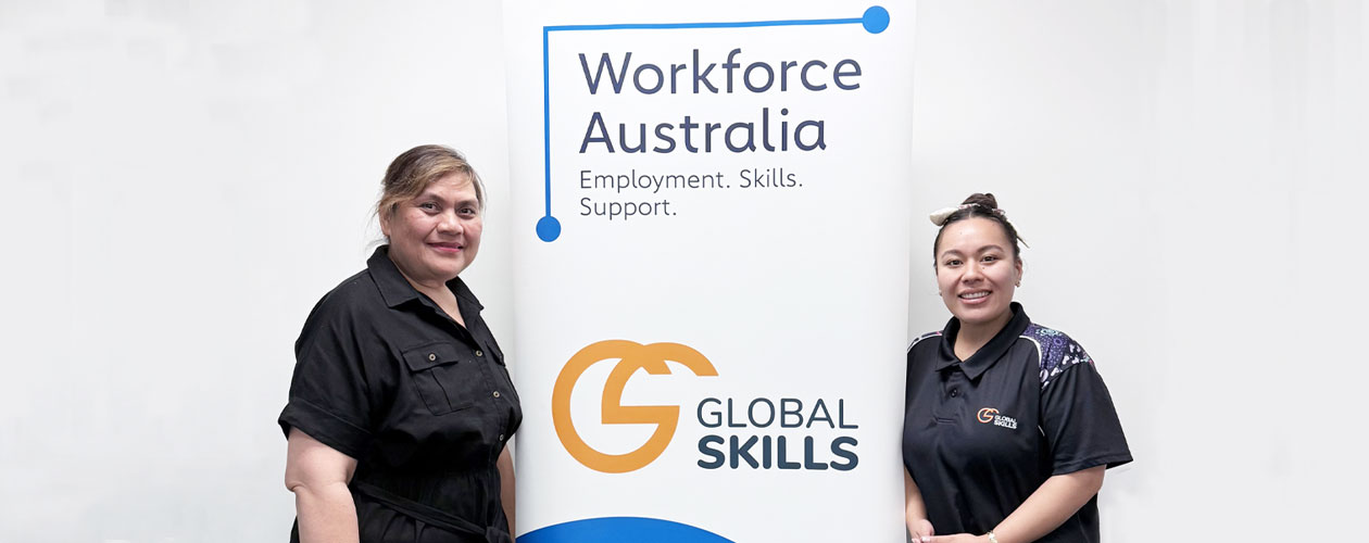 Ofa and Chevaugh standing on either side of Global Skills’ Workforce Australia banner. The banner displays Workforce Australia branding above our Global Skills logo.