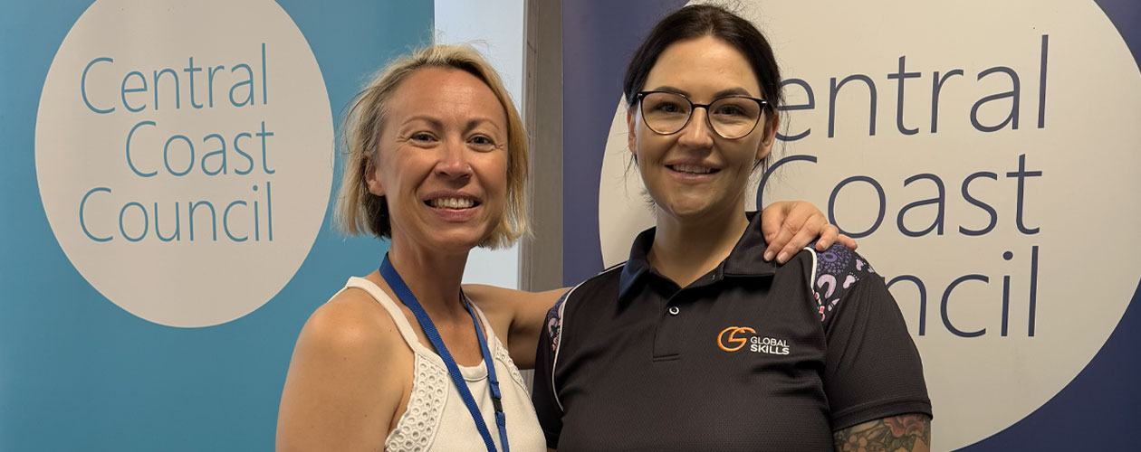 Renee and Chloe smiling and standing in front of Central Coast Council banners.