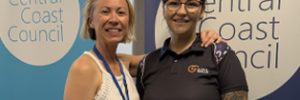 Renee and Chloe smiling and standing in front of Central Coast Council banners.