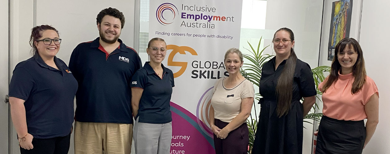 Trainers and Campbelltown staff in front of Global Skills banner