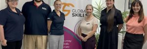 Trainers and Campbelltown staff in front of Global Skills banner