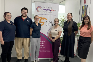Trainers and Campbelltown staff in front of Global Skills banner