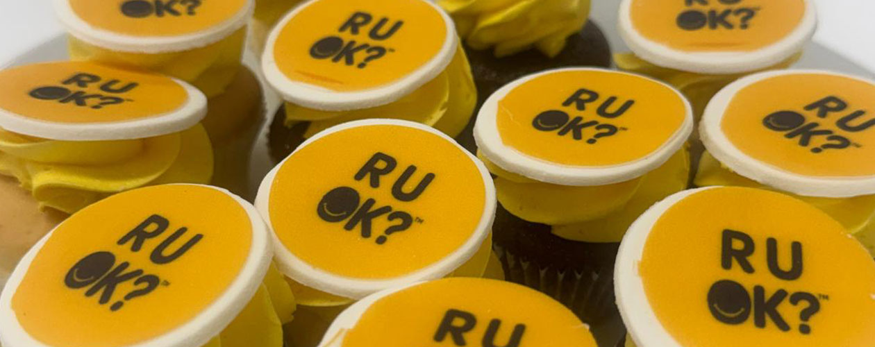 Cupcakes with the R U OK? logo printed on yellow icing