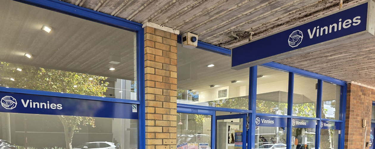 Front entrance of a Vinnies store with blue signage